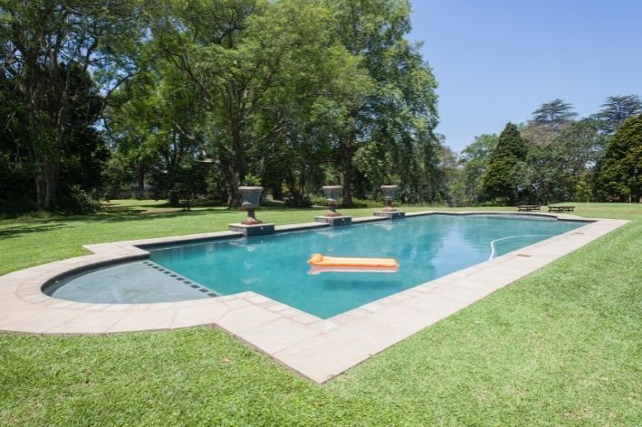 decoração de piscina com grama ao redor